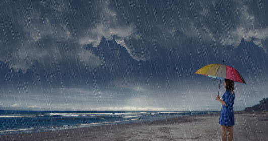 mulher com guarda-chuva na praia