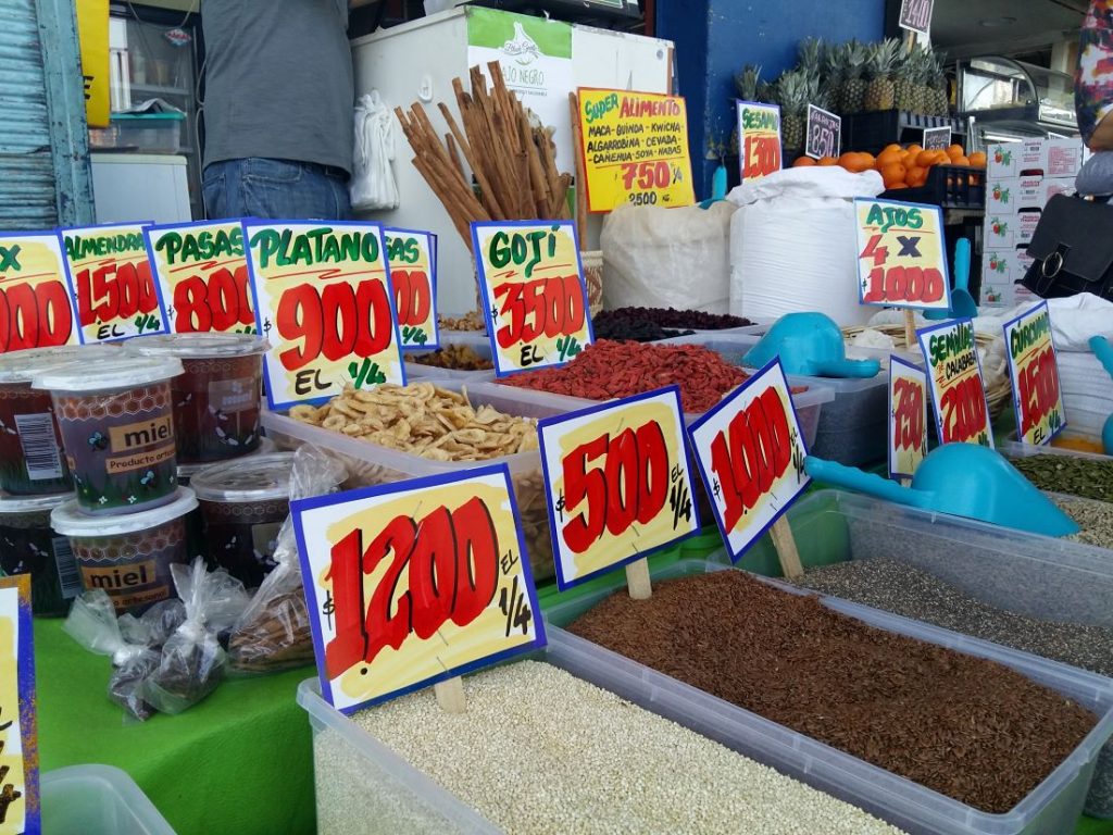 Imagem mostra barraca de feira com temperos.